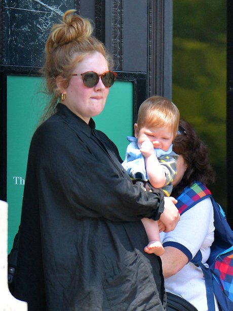 Adele with her baby Angelo wearing black