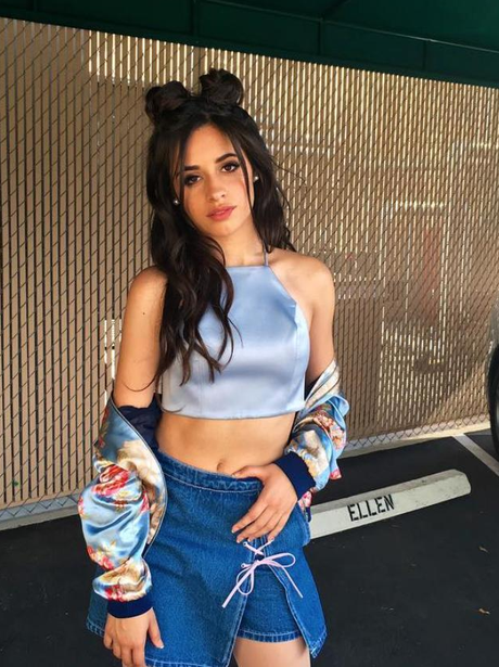 Camila shows off her enviable stomach in a short denim skirt and blue